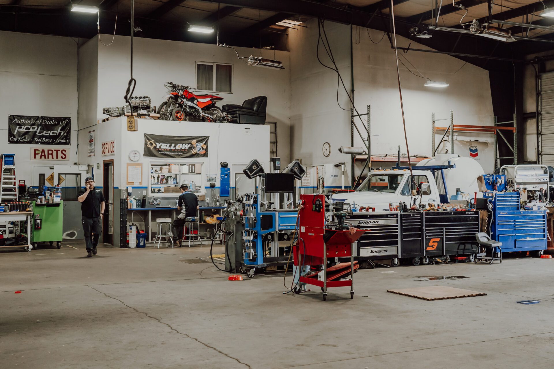 Two men are in the garage Two men are in the garage