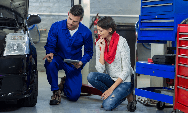 Mechanic showing customer the problem with car (1) mechanic showing customer the problem with car